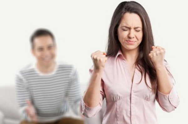 Женщина пытается не взорваться. На заднем плане сидит мужчина