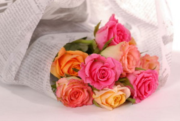 Оборачивание газетой букета роз