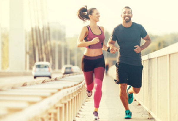 Счастливые парень и девушка занимаются пробежкой
