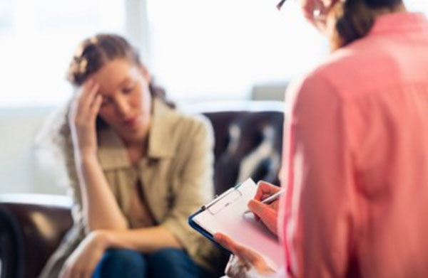 Психотерапевт общается с женщиной