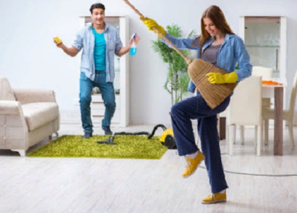 Парень с девушкой занимаются уборкой. Но делают из этого веселье